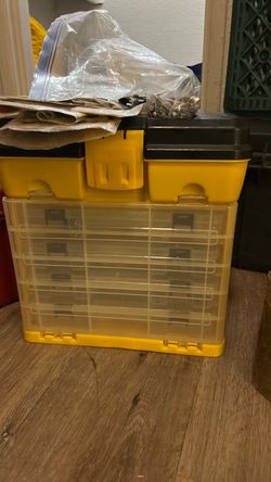 collection of assorted plastic organizer cases filled with hardware, small components, and rotary tool accessories.