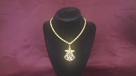10K gold. This is a handsome, solid gold 24 inch rope chain with a sailors cross pendant. 48. GRMS. $2,350.00.