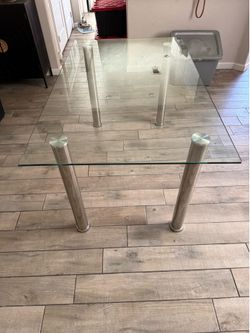 Solid glass table with stainless steel legs. Fits 6 chairs