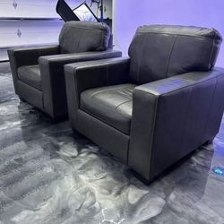 Premium Italian-style leather lounge chairs, selling as a pair.