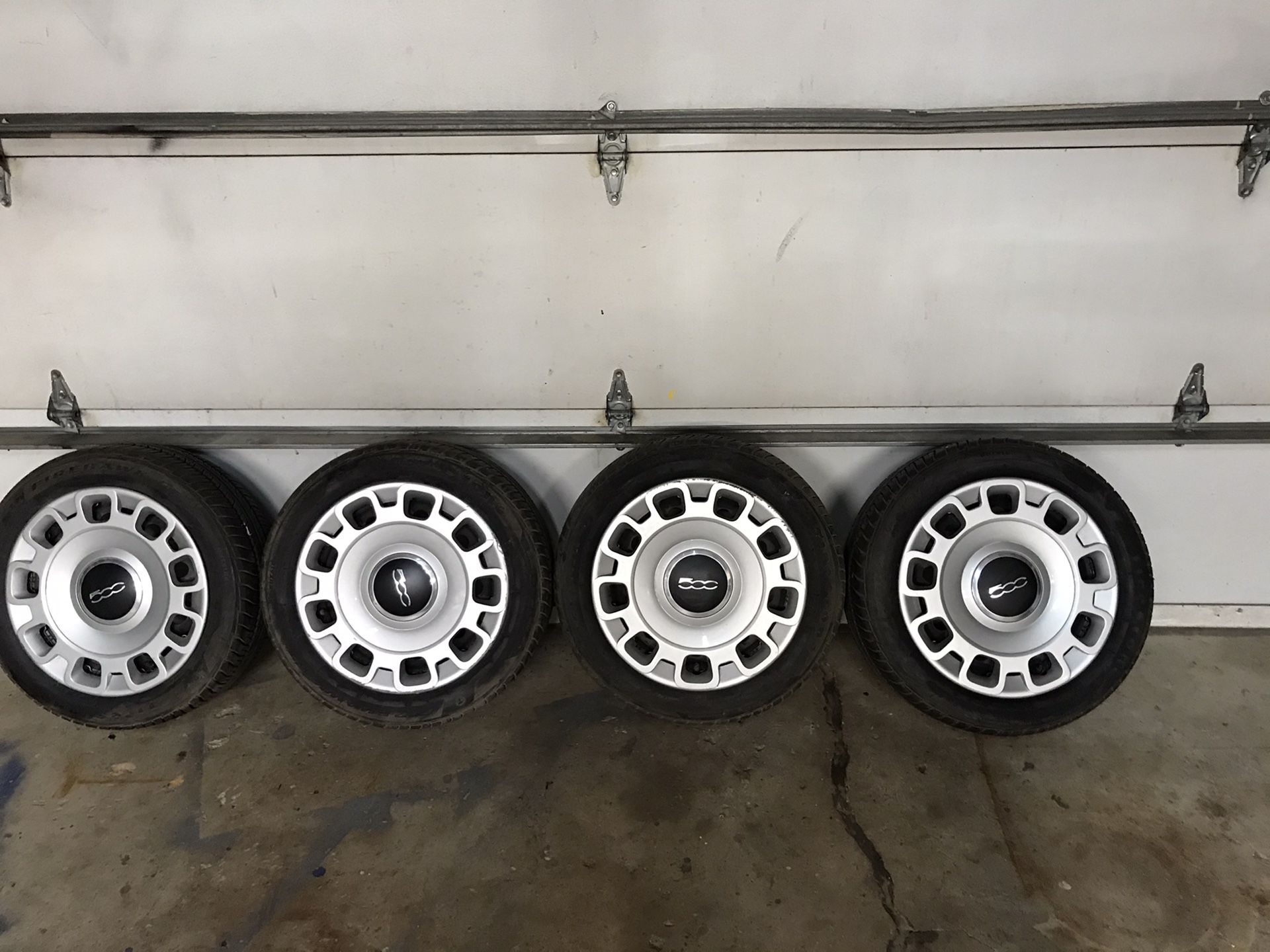Fiat steel wheels with tires and hub caps. 185/55r15