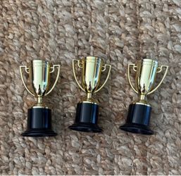 Set of three gold mini trophies plastic with black bases. Costume awards