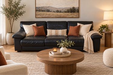 Modern leather 3-seat sofa with a foldaway bed.