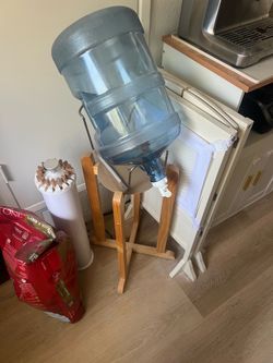 Eight 5 gallon Water jugs. Plus stand