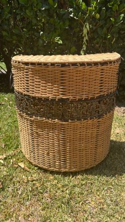 small wicker hamper with metal leaf decoration and feet