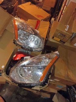 headlight assembly designed for a 2008-2013 Nissan Rogue.The component features a chrome housing with an amber reflector.