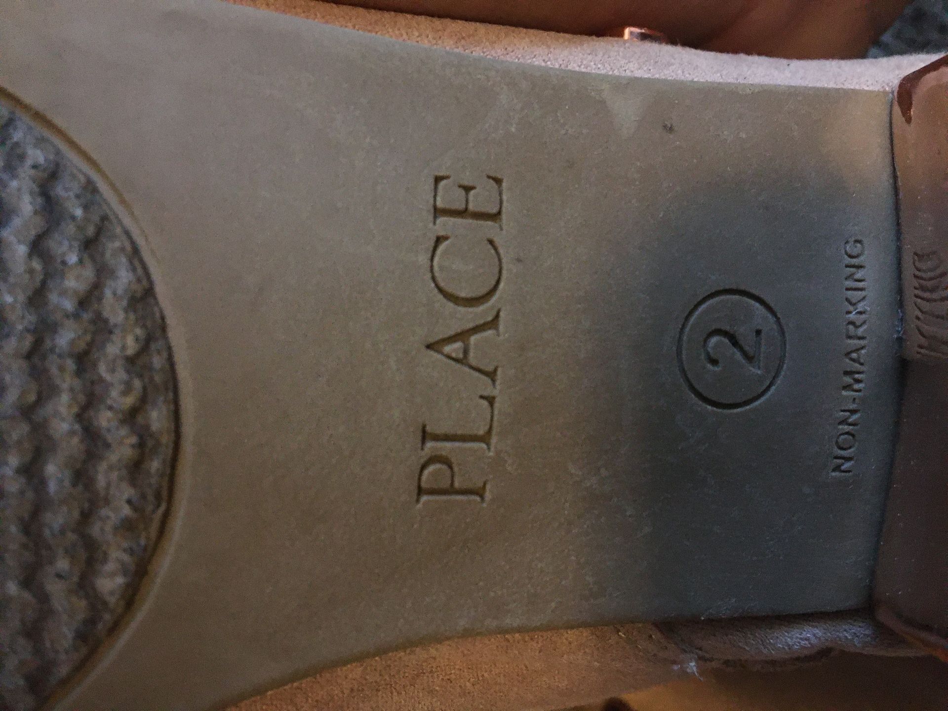 Children place girl shoes