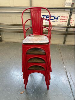 4 Red Metal chairs with wood seat.