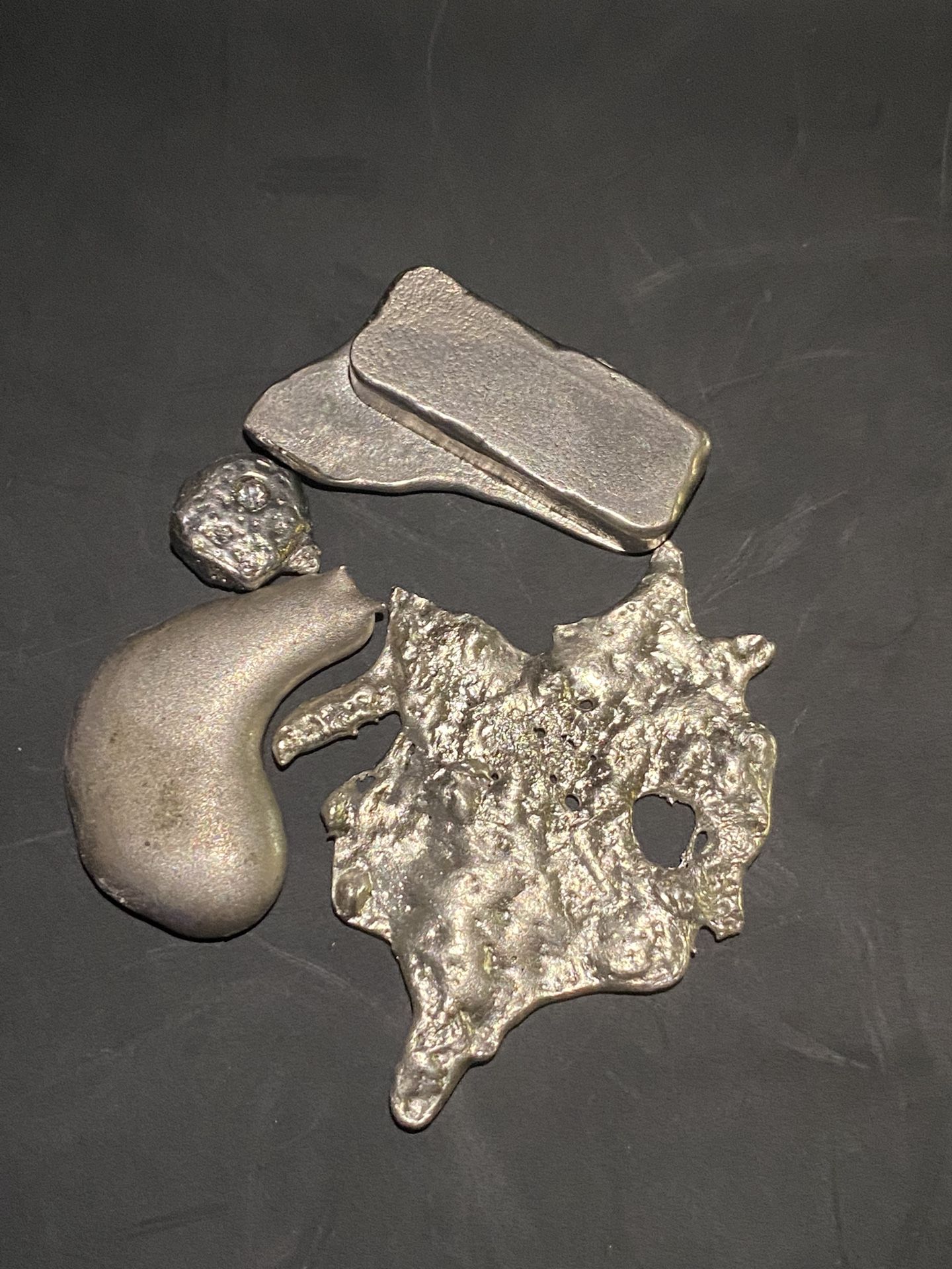59.54 of silver shot melted down into these four individual pieces 1with real do