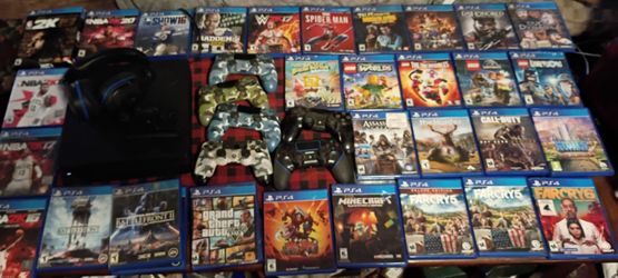 PlayStation 4 with gaming console and headset and six controllers with rechargeable unit and on top of that 32 games