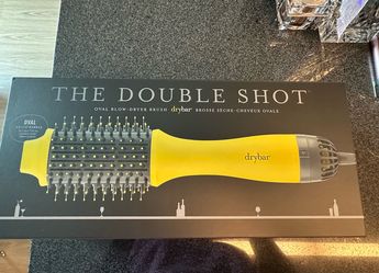 Brand new Drybar Double Shot Oval Blow-Dryer Brush. Never used. Comes with the original box and packaging. Perfect condition. Retails for $155.