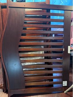 "Wooden baby crib that converts into a bed"