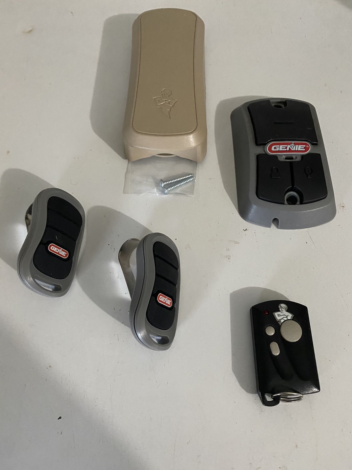 Genie Garage Door Car Remotes(2), Keychain Remote(1), Wall Button(1), Key Pad (1).