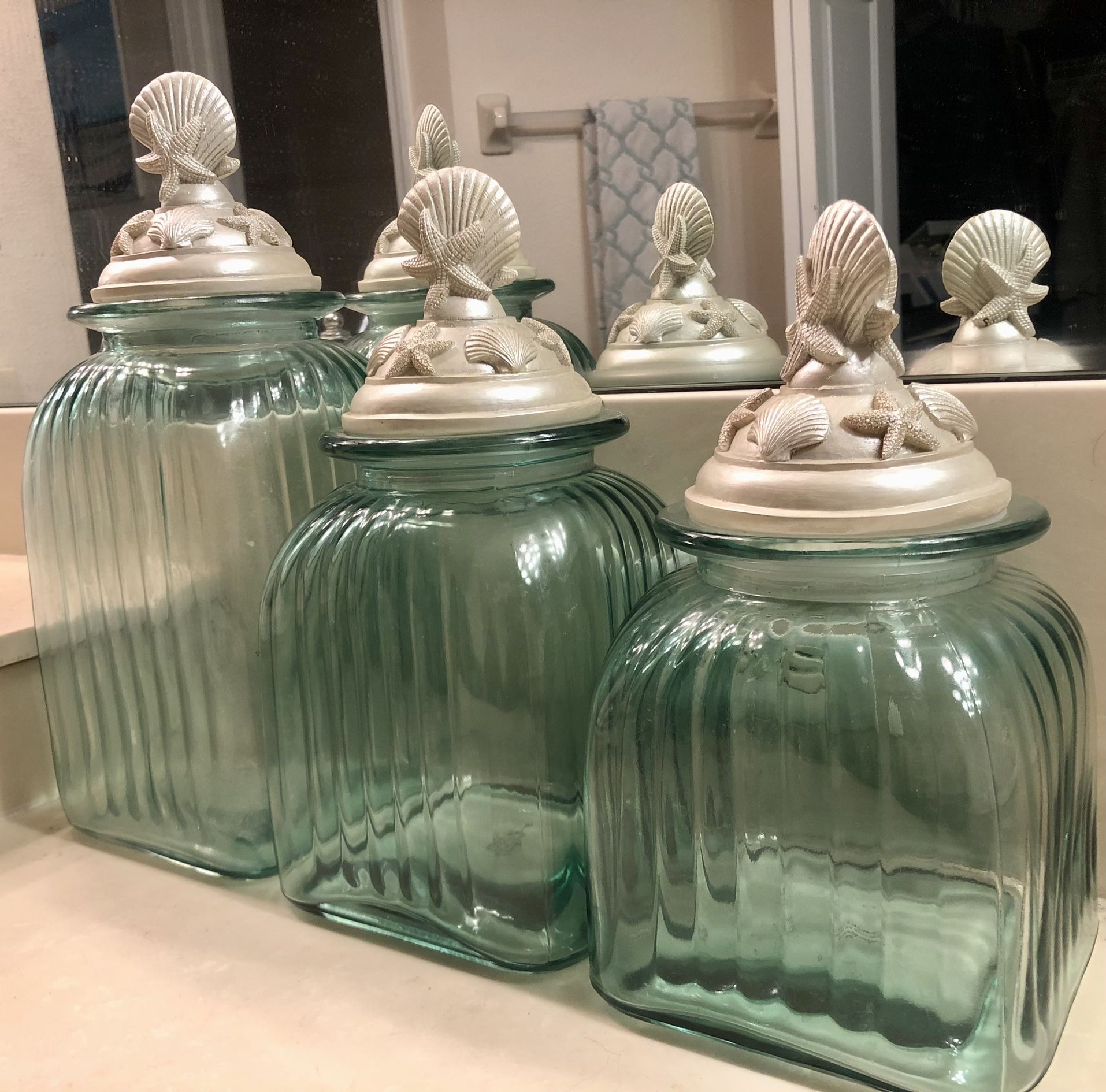 Set Of 3 Aqua Glass Ribbed Canisters With Decorative Coastal Shell Lids