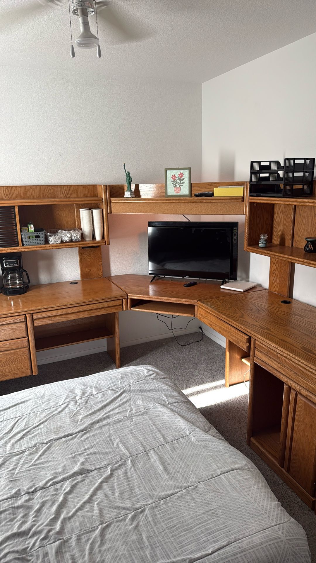wooden home office desk with integrated storage and a hutch.