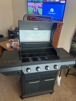 Nexgrill 4-Burner Propane Gas Grill with side burner and storage doors