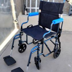 Nova Lightweight Transport Chair with a lightweight aluminum frame. Designed for convenience and safety, it features built-in handles for easy lifting