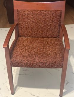 Two wood frame upholstered chairs