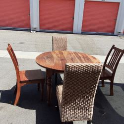 solid wood table with 2 wooden chairs and 2 covered chairs in excellent condition