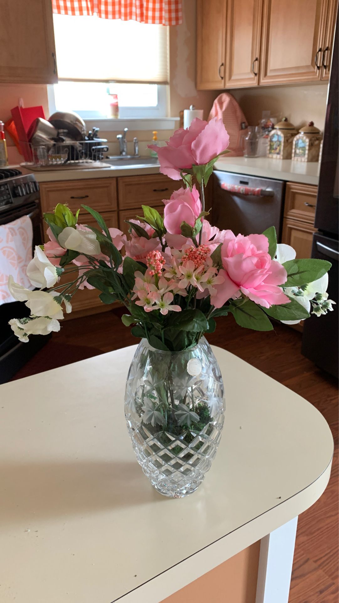 Pink faux flowers in cute glass vase
