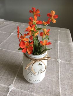 Distressed mason jar vase with silk orange flowers $5