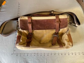 tan waxed canvas messenger bag with brown leather detailing
