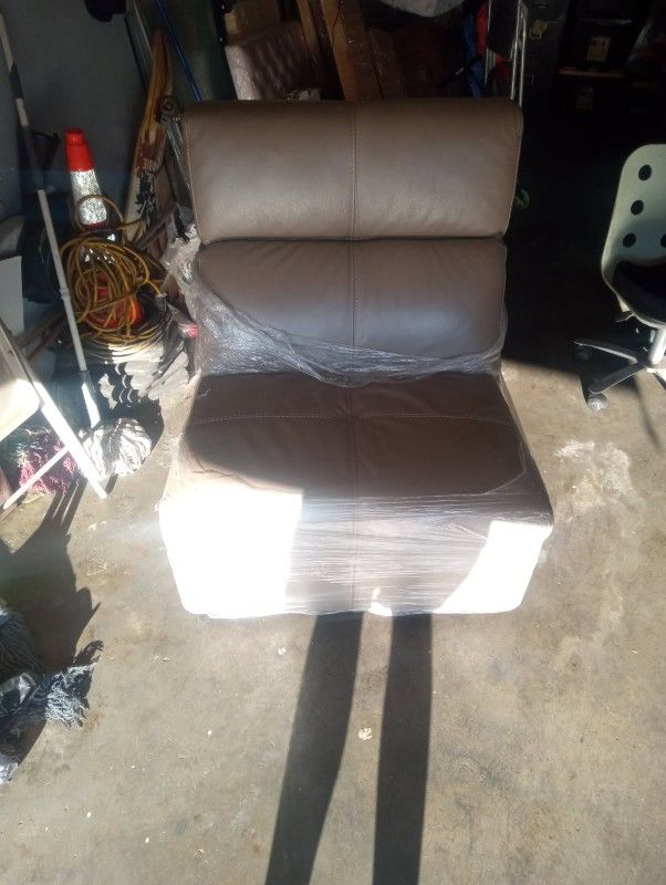 Beige, leather sectional couch piece.