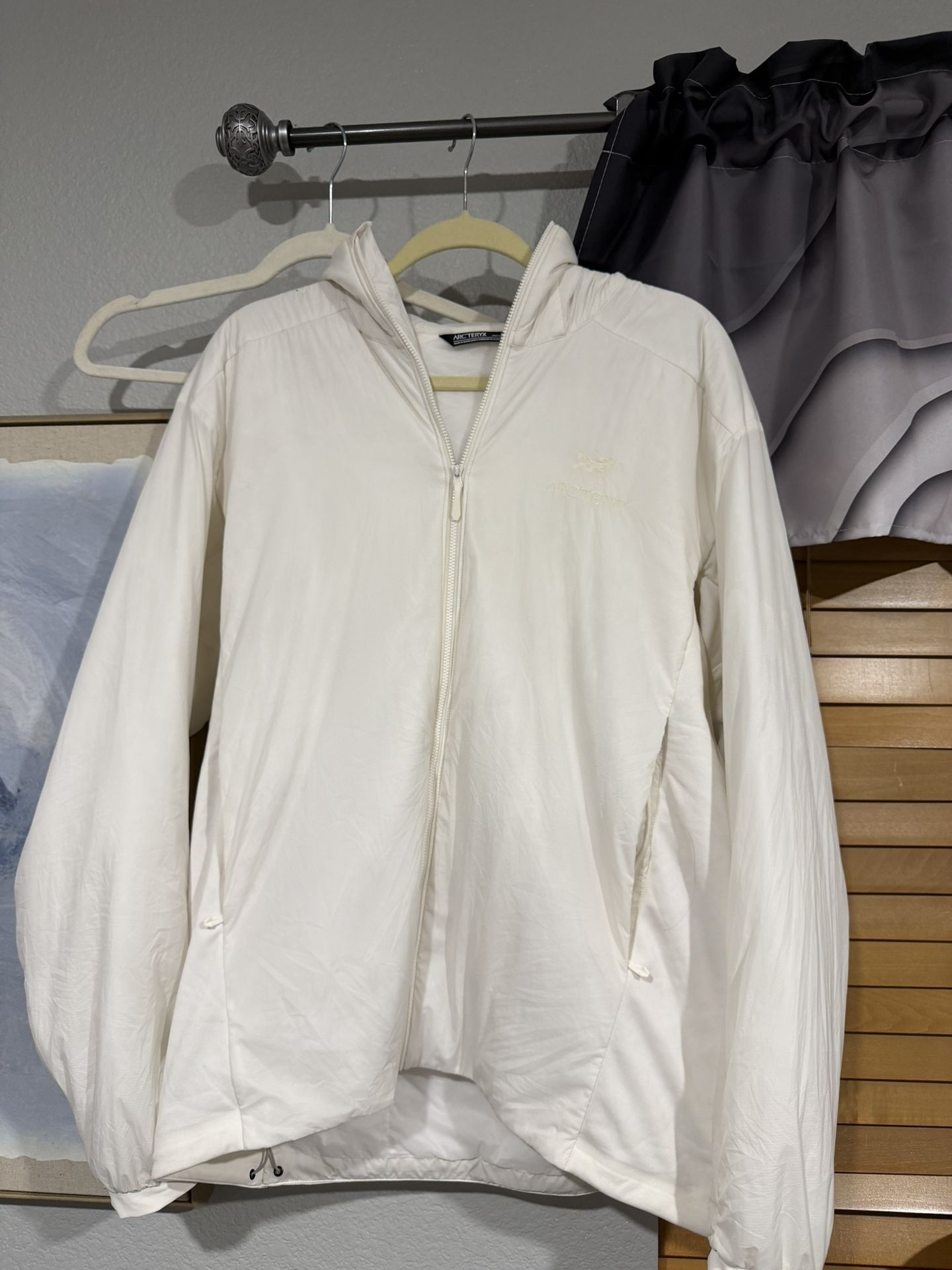 white arc’teryx lightweight windbreaker jacket