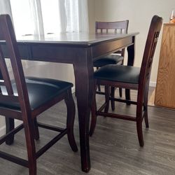 Formal dining table with four chairs and leaf normal wear and tear couple scuffs. $300