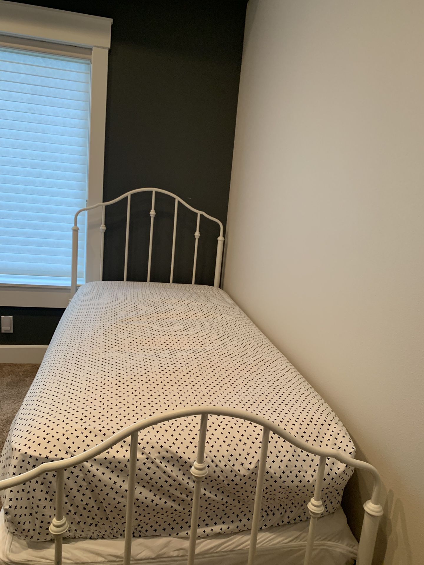 Twin bed frame with mattress and box spring.