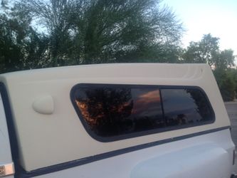 Fiberglass camper shell Nice shape. Tint, all glass good, will include mounting hardware and rubber boot Fits Full size long bed
