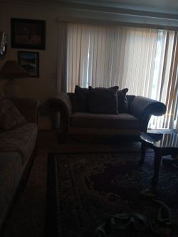 A set of gray couches. No tiars.