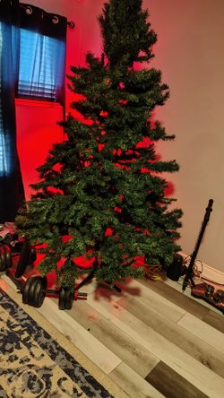 8 ft high Christmas tree three sections comes with skirt and legs and carrying case and lights balls and all the trimmings brand new I just want a hun
