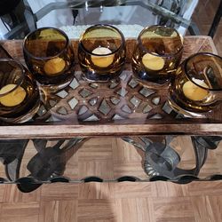 Wooden and glass centerpiece candle holder with a design featuring 5 amber candle holders.