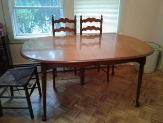 Antique maple dinning room table with felt table top protector.