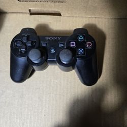 Black Sony PlayStation DualShock 3 Sixaxis controller.