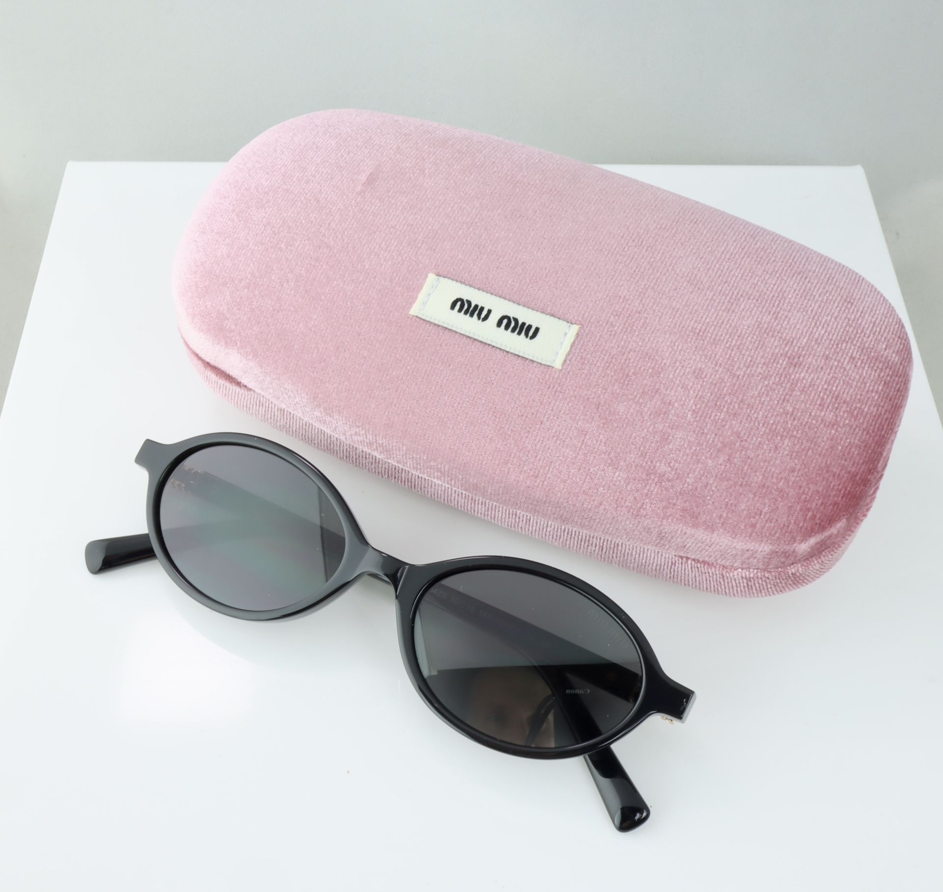 Miu Miu Oval Sunglasses in Black with Gray Lens