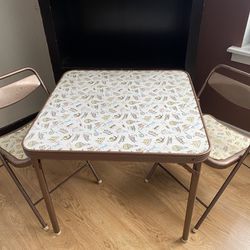 Kids metal folding  table & 2 chairs , see 1 edge of table has light rust, from sitting on a concrete floor*priced accordingly