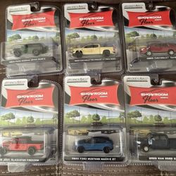 Set of six GreenLight Showroom Series diecast cars. Includes various models in black, yellow, red, and blue.
