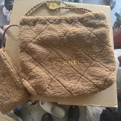 brown shearling Chanel 22 hobo bag from the 23B collection.