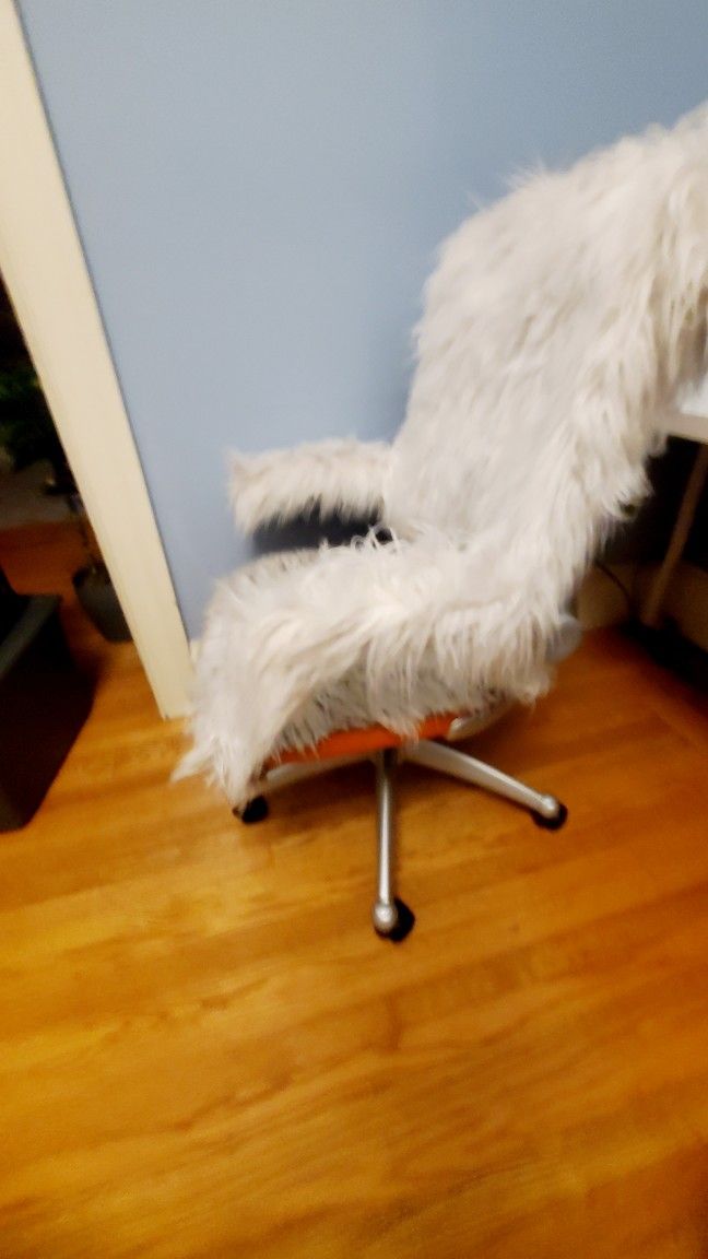 2 Desk chairs $19 ea OBO. Faux fur covering, orange base color