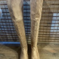 over-the-knee soft suede boots with laces and rubber sole.
