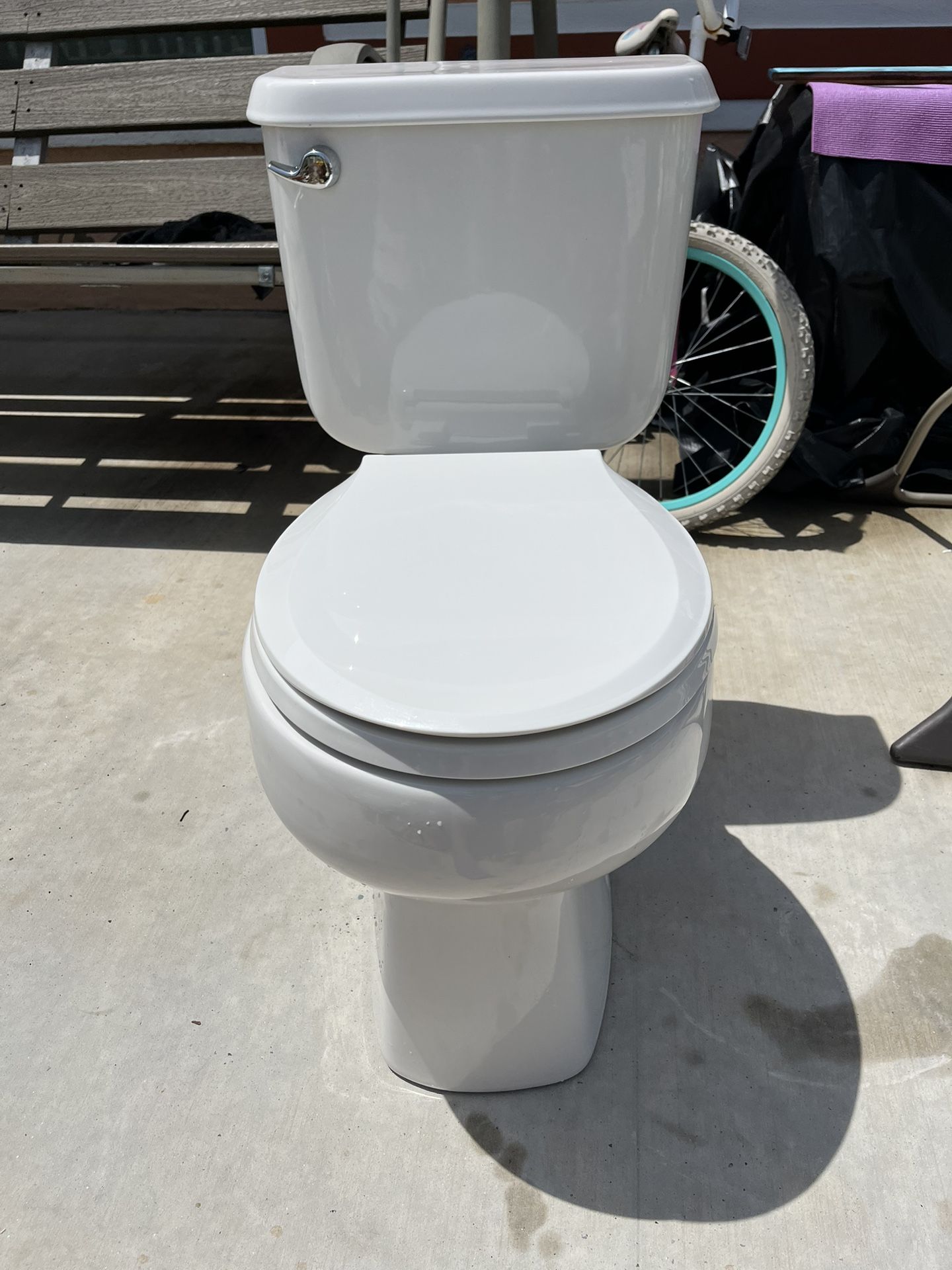 Toilet in good condition, very clean, measures 16 inches high
