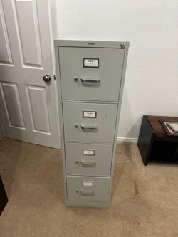 Metal finding cabinet four drawer,  all drawers open and close smoothly.  All of them have the divider in the middle that can be moved around . no key