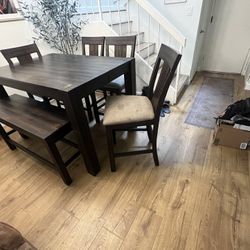 Dining table, bar height (36”), 54” x 36”, expands up to 54”x54”. Minor staining on chairs, other than it is in good condition. 