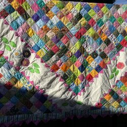 Vibrant Patchwork Quilt With Flower Border