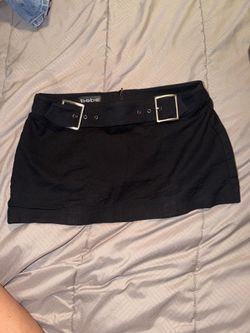 bebe black mini skirt features prominent silver hardware buckle size 4