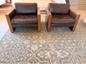 Mid Century Style Bastiano club chairs, featuring a brown leather and wooden