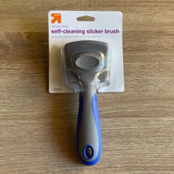 Self-cleaning slicker brush