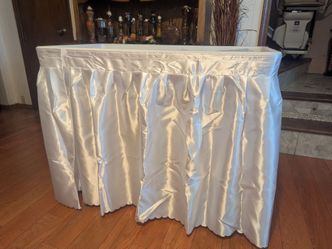 Large Cooler foldable table that holds ice to keep food cold for events. To with detachable skirt.